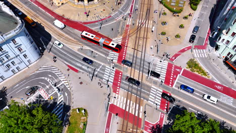 cars and bus crosses the crossroads with white and red marking. descending above the roads in bratislava, slovakia