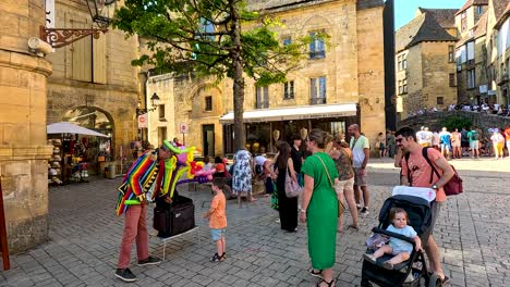 clown entertaining people in a bustling square