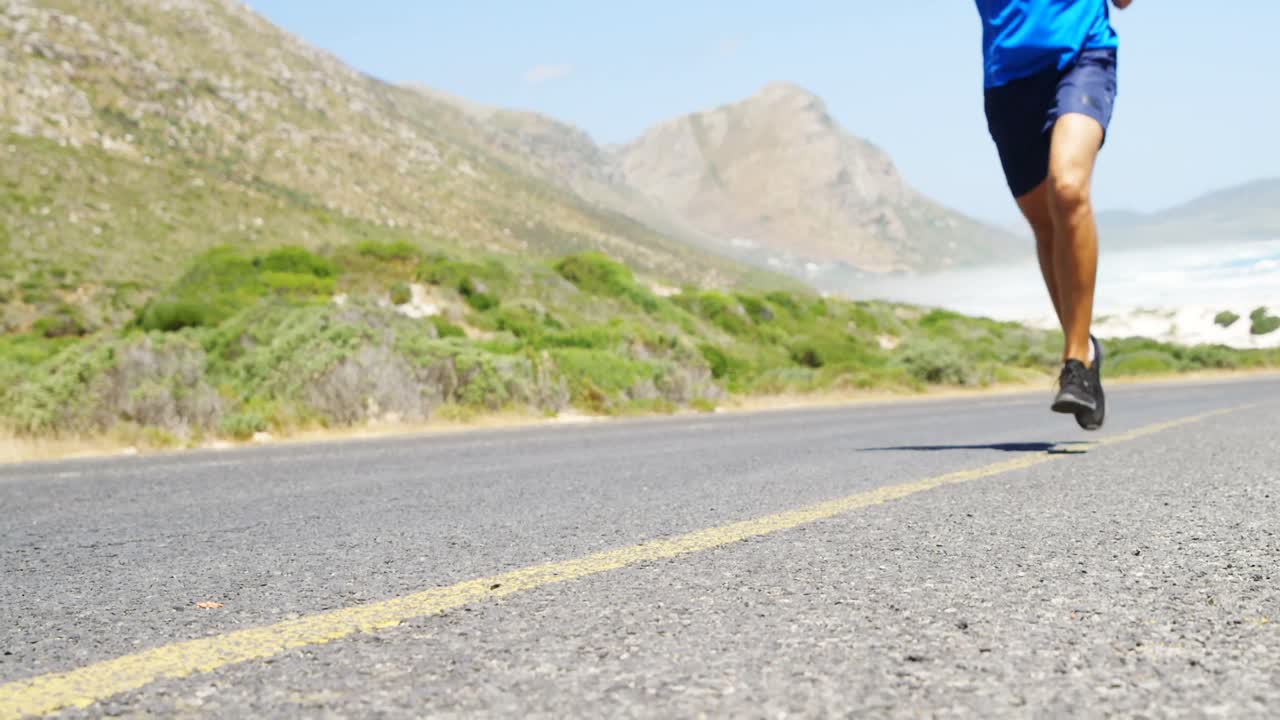 Triathlete man jogging in the countryside road