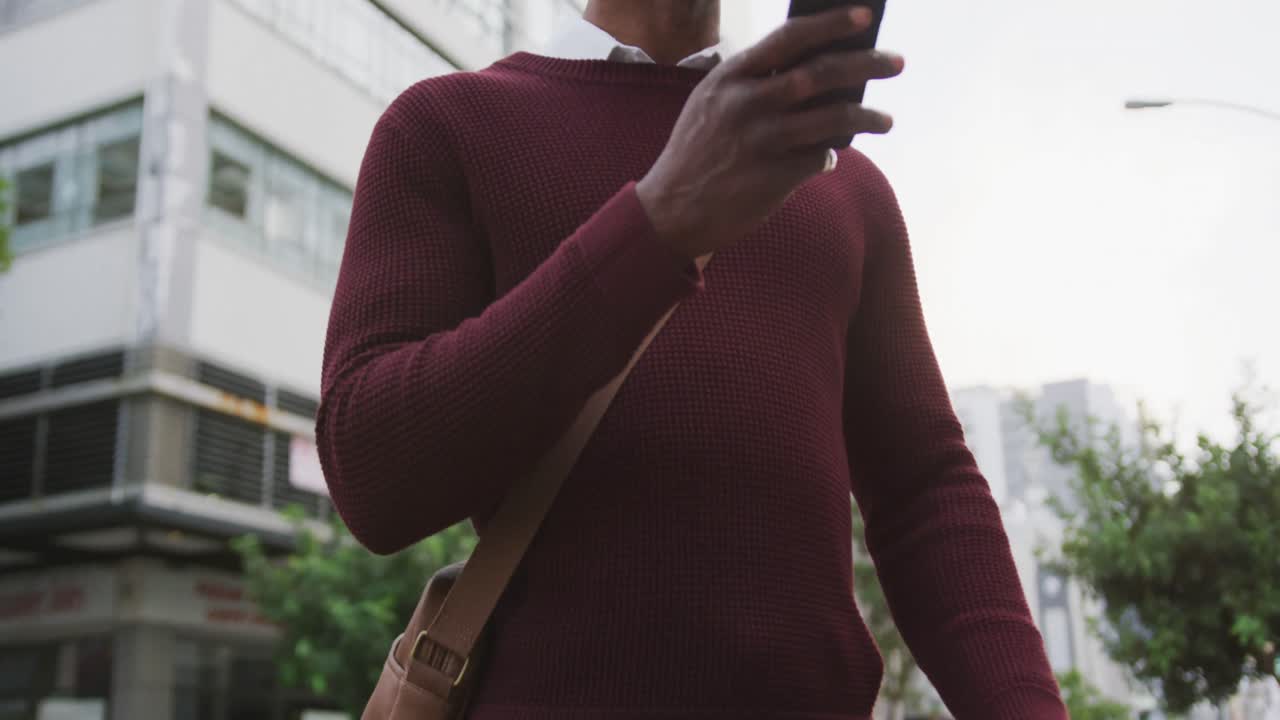 African American man using his phone in the street