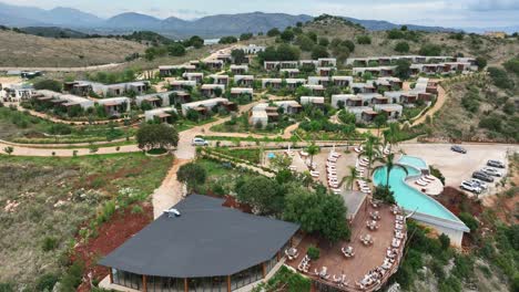 hotel resort in albania featuring a pool and cozy houses for sleep, rest, and peaceful vacation.