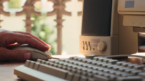 Man working and gaming on retro computer PC, IT engineer with vintage computer at home, using old fashion technology, close up of retro setup.