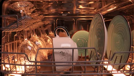 open dishwasher with clean dishes. housekeeping concept.