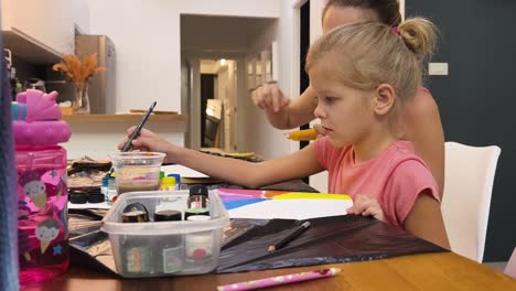 mother and daughter painting together