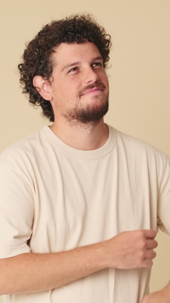 Man with curly hair looking up