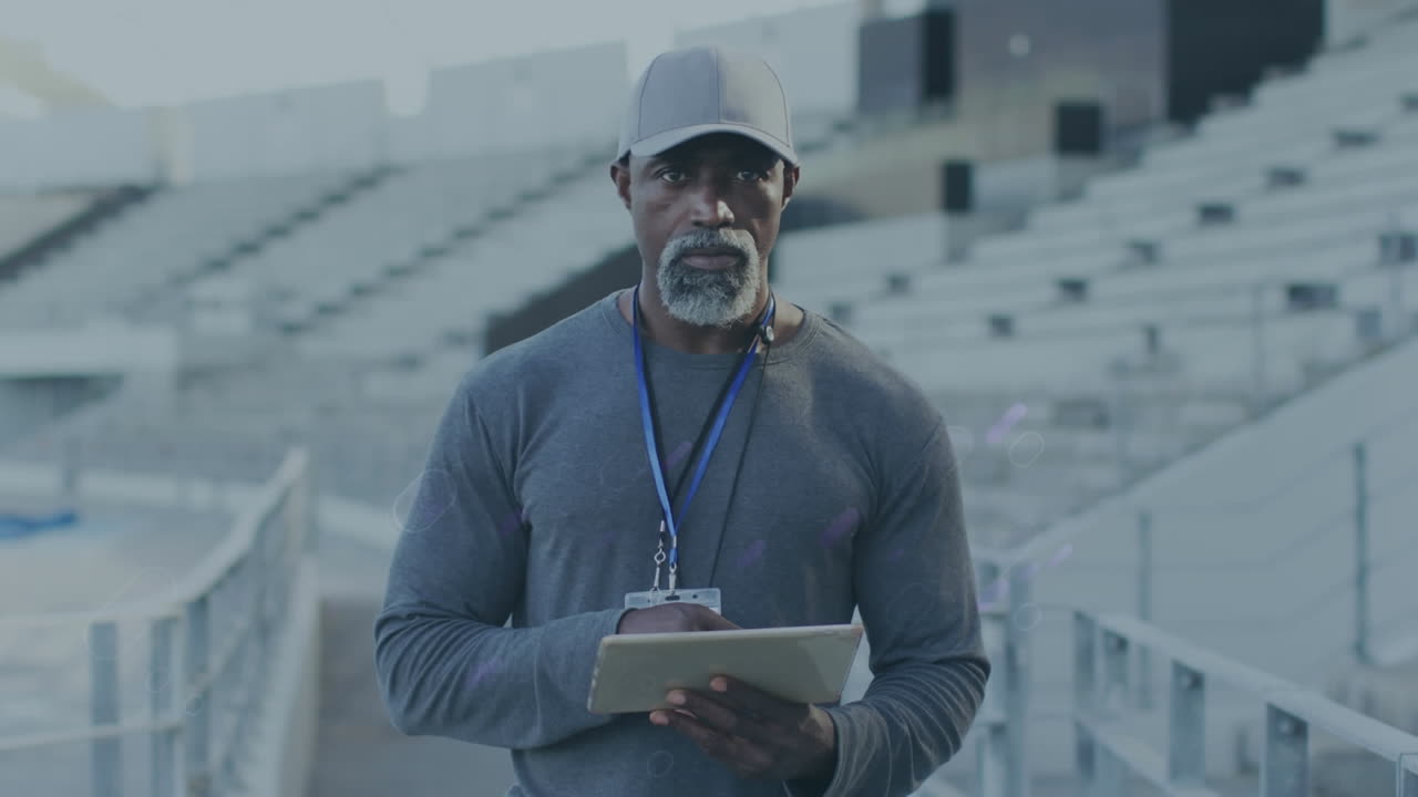 Animation of blue trails over african american coach with tablet