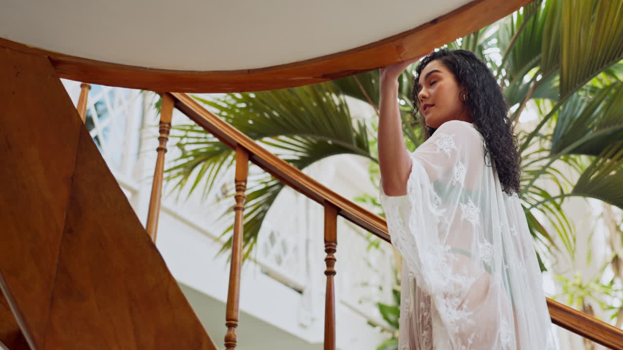 Woman on stairs with palm tree