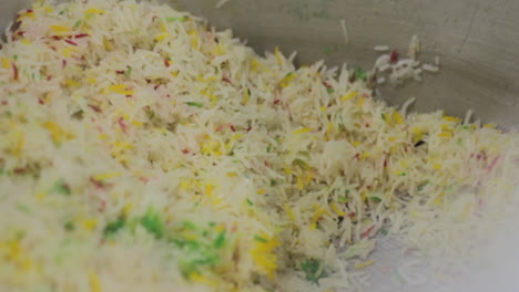 ready meal production line in a factory, a close up view of cooked sweet colored rice