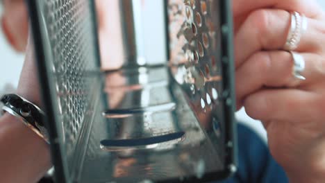 grate-cheese-with-a-grater-while-cooking