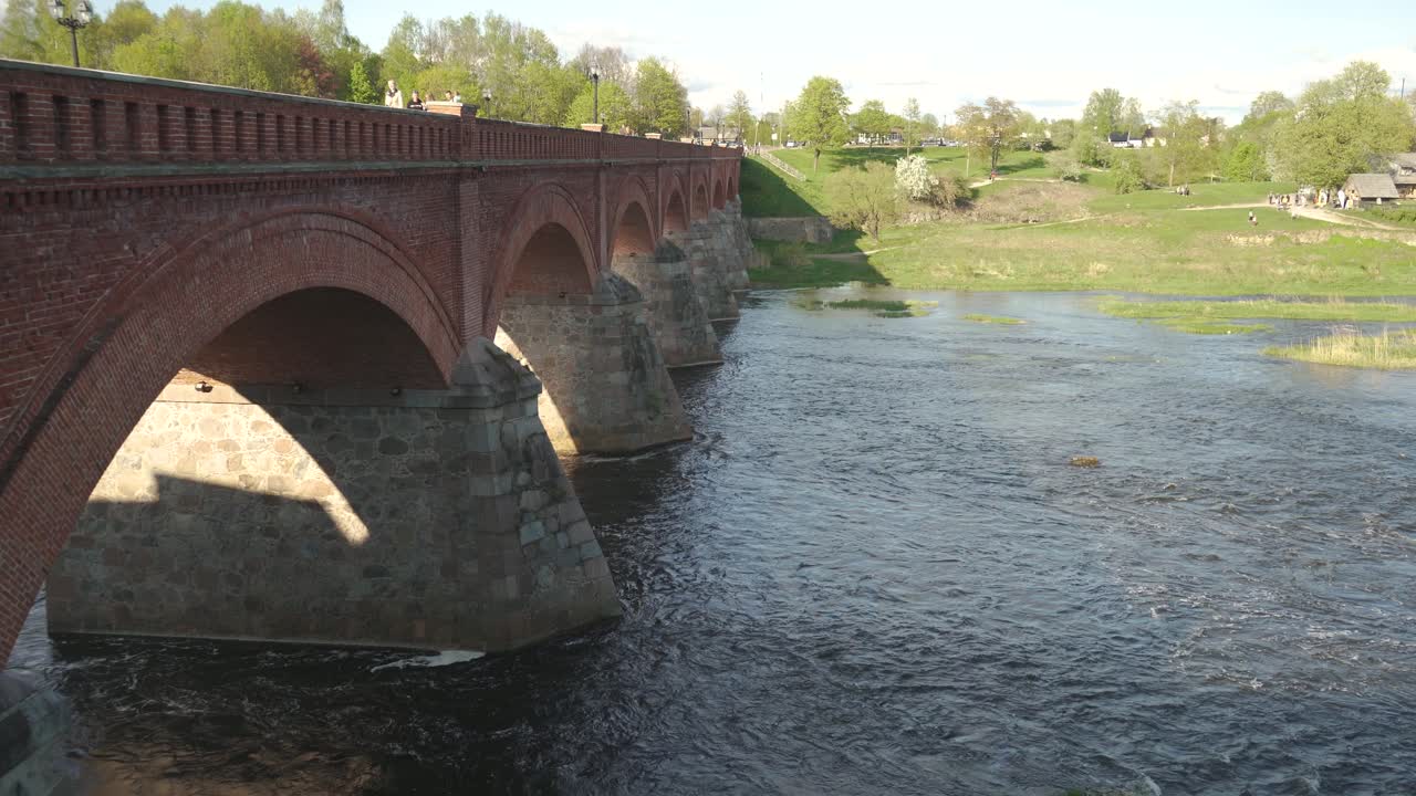 largo puente de ladrillo antiguo, kuldiga, letonia a través del río venta
