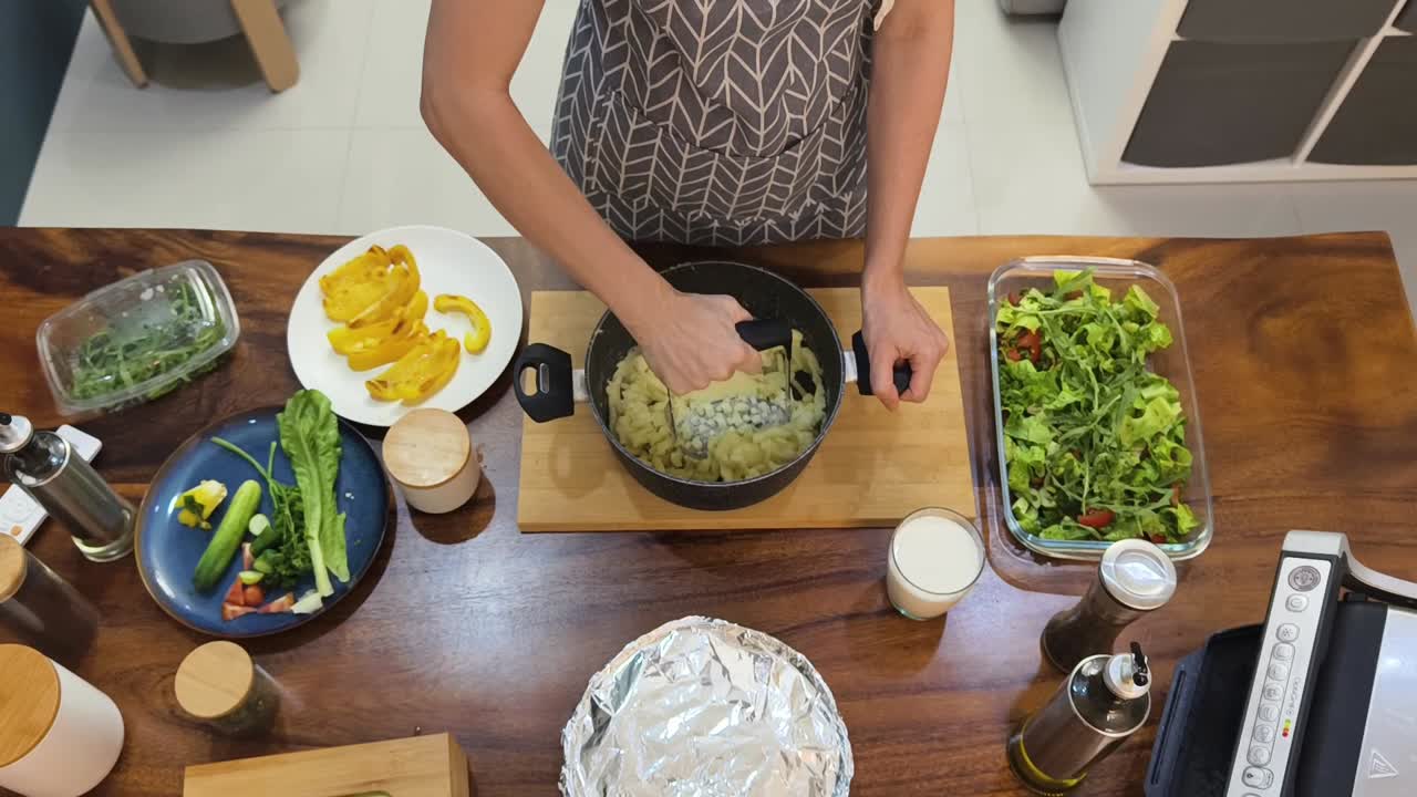 Preparing a Meal with Mashed Potatoes and Salad