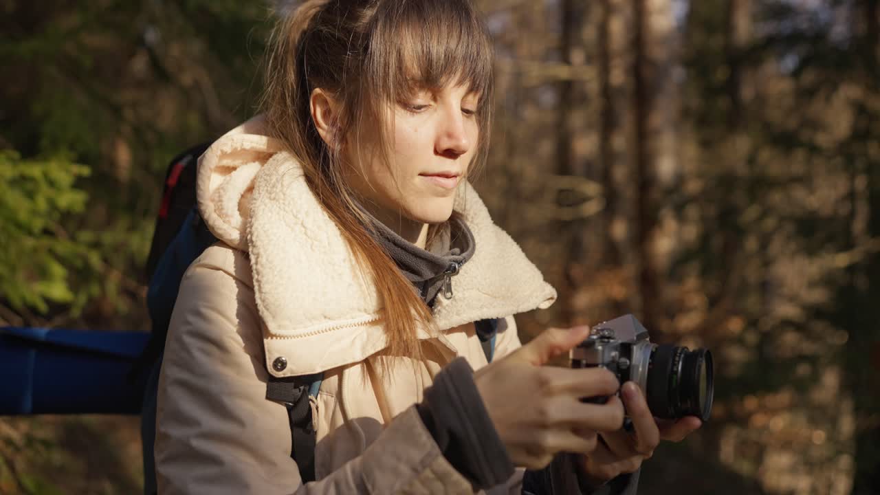 Woman taking pictures in the forest