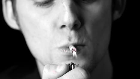 Man-lighting-up-a-cigarette-in-black-and-white