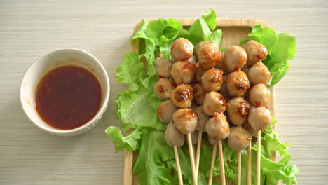 grilled meatballs skewer with spicy dipping sauce