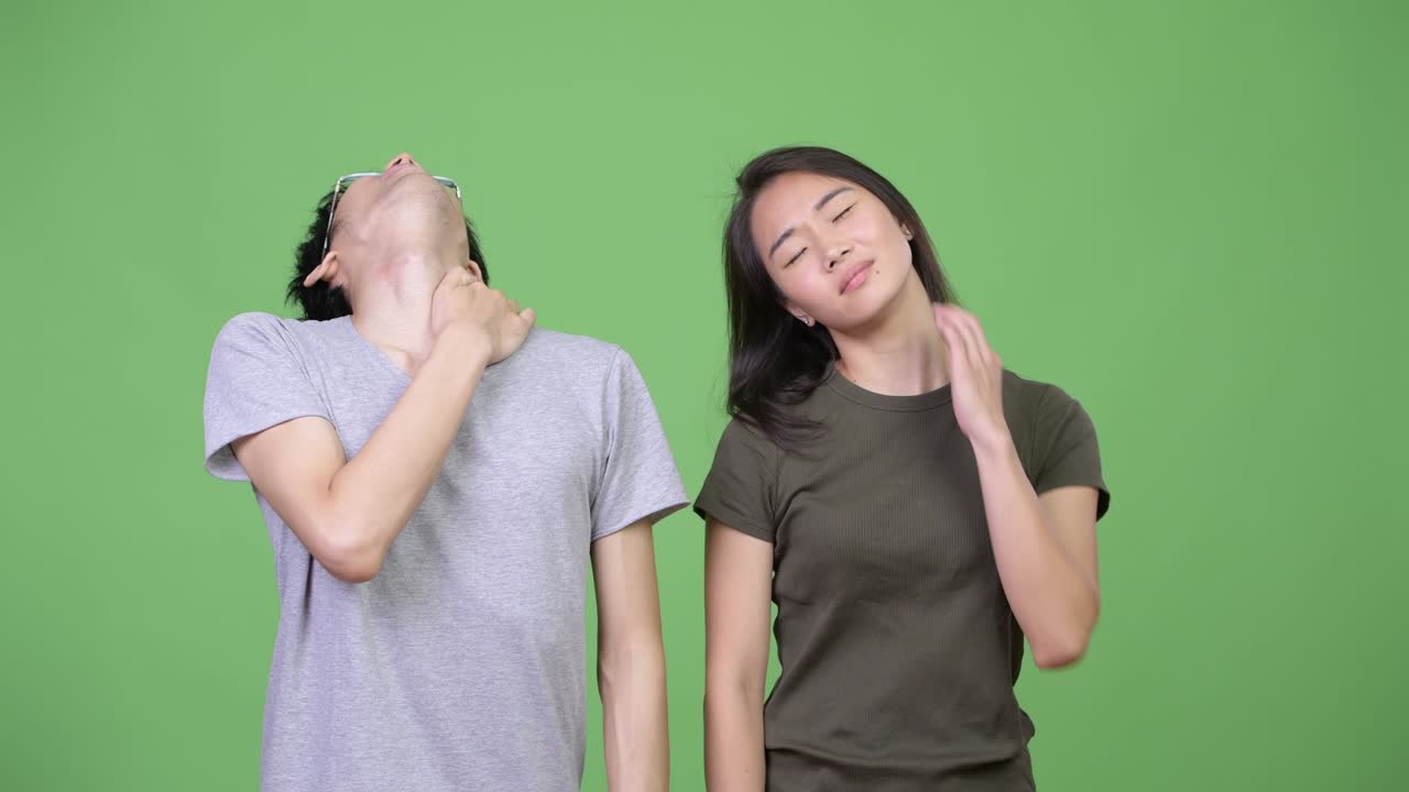 Young Asian couple having neck pain together