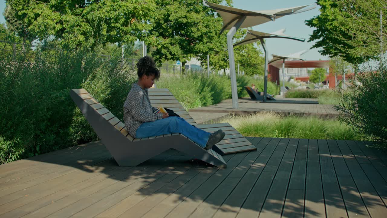 Woman Relaxing on Lounge Chair in a Park