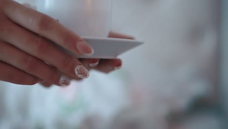 Young-man-gives-the-girl-a-cup-of-coffee-in-the-morning-close-up-slow-motion-2