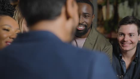 Tracking-Shot-of-Group-of-Friends-Talking-and-Laughing-In-a-Bar