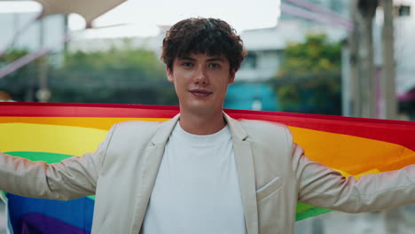 man with rainbow flag representing lgbtq+ pride