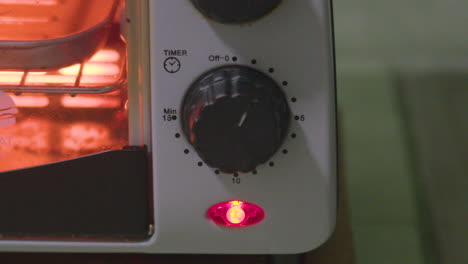 close up timelapse shot of convection toaster timer moving in fast motion