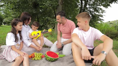 smiling big friendly family with children spending time together at picnic at the city park smiling big friendly family with children spending time together at picnic at the city park high quality footage