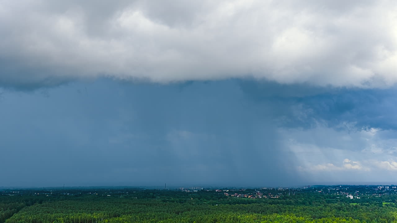 Dense Clouds Scattered Over Thicket Forests Near Rural Town. Timelapse