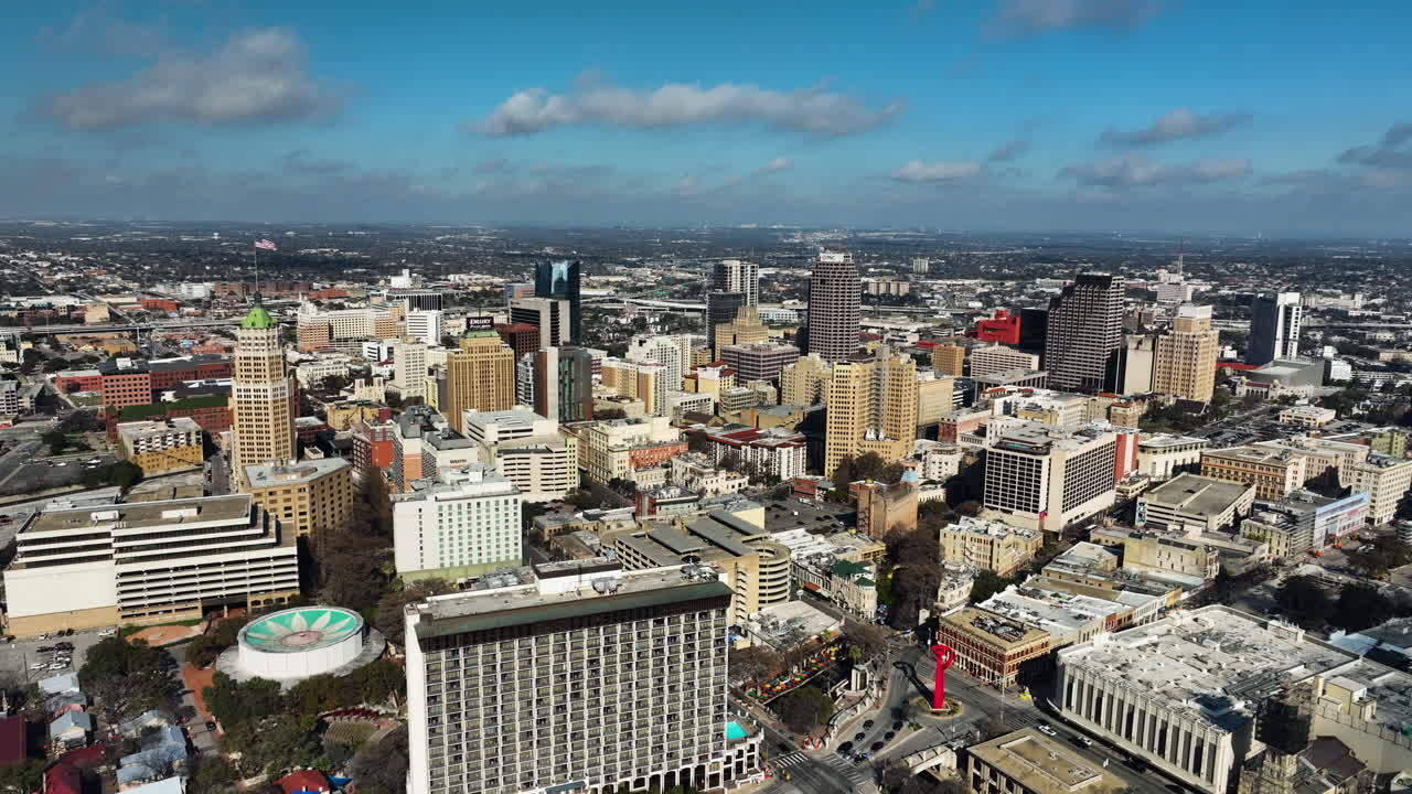 Aerial view backwards over downtown San Antonio, sunny evening in Texas, USA
