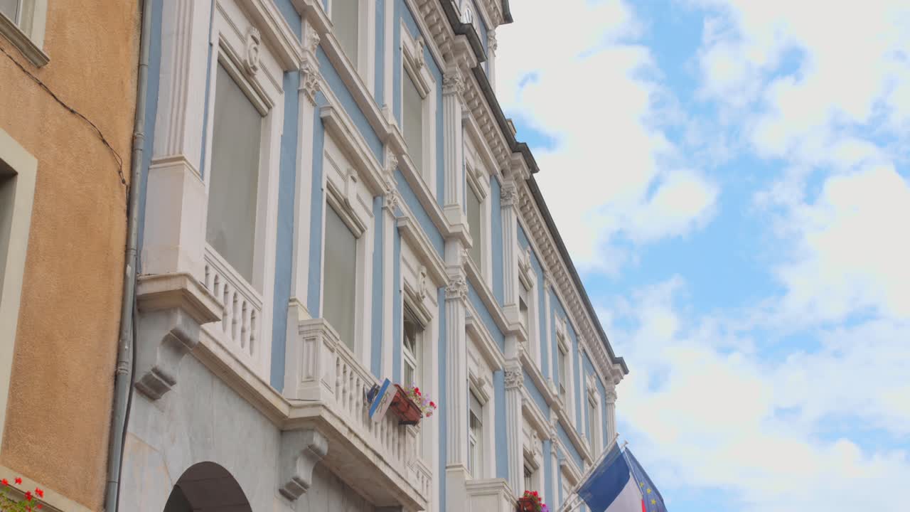 Low angle view of vintage architecture shot of buildings and houses in Vizille, France during daytime. 4k.