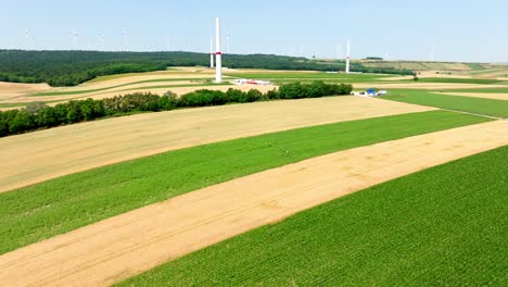 Aerial-View-Of-Wind-Farm-Under-Construction-In-Summer---drone-shot