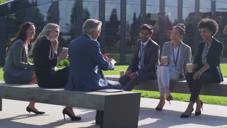 multi-cultural business team sitting outside office for coffee break have informal meeting