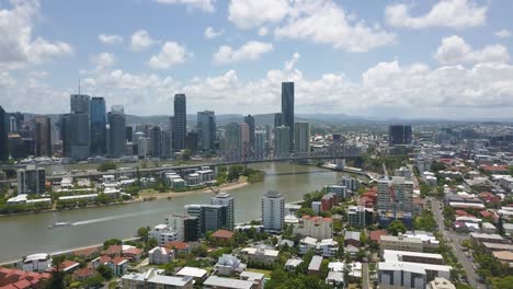 aerial establishing overview of brisbane suburb on riverside bank across bridge