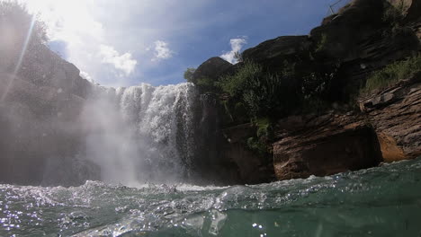 over-under water level view of lundbreck waterfall, alberta from below