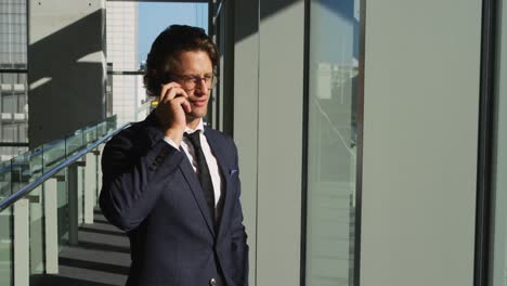 Businessman-on-smartphone-in-a-modern-office-building