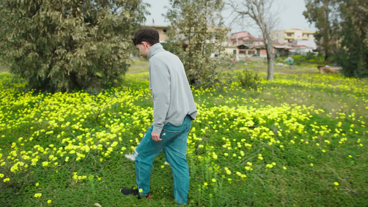 Man Having A Walk In The Green Grass In Search Of Flowers