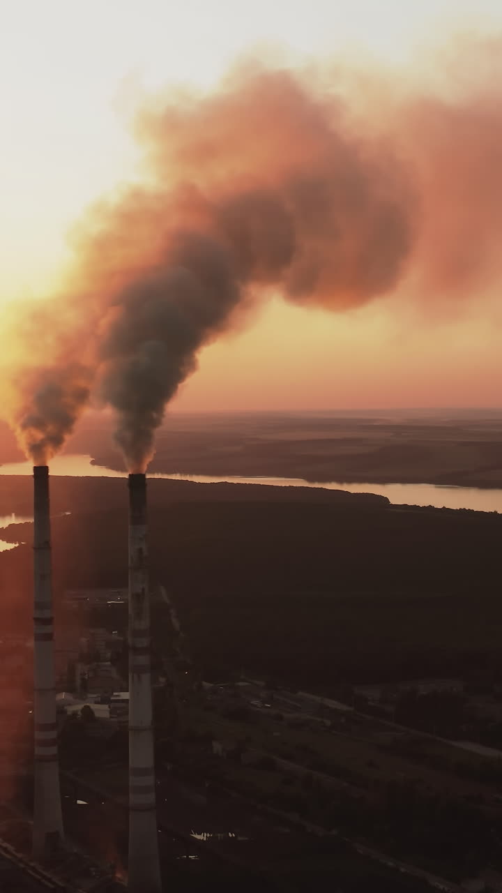 Environmental problem of pollution ecology. Aerial view of high chimney pipes with smoke from power plant