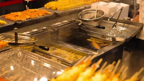 chef frying tempura, flames rising from hot oil