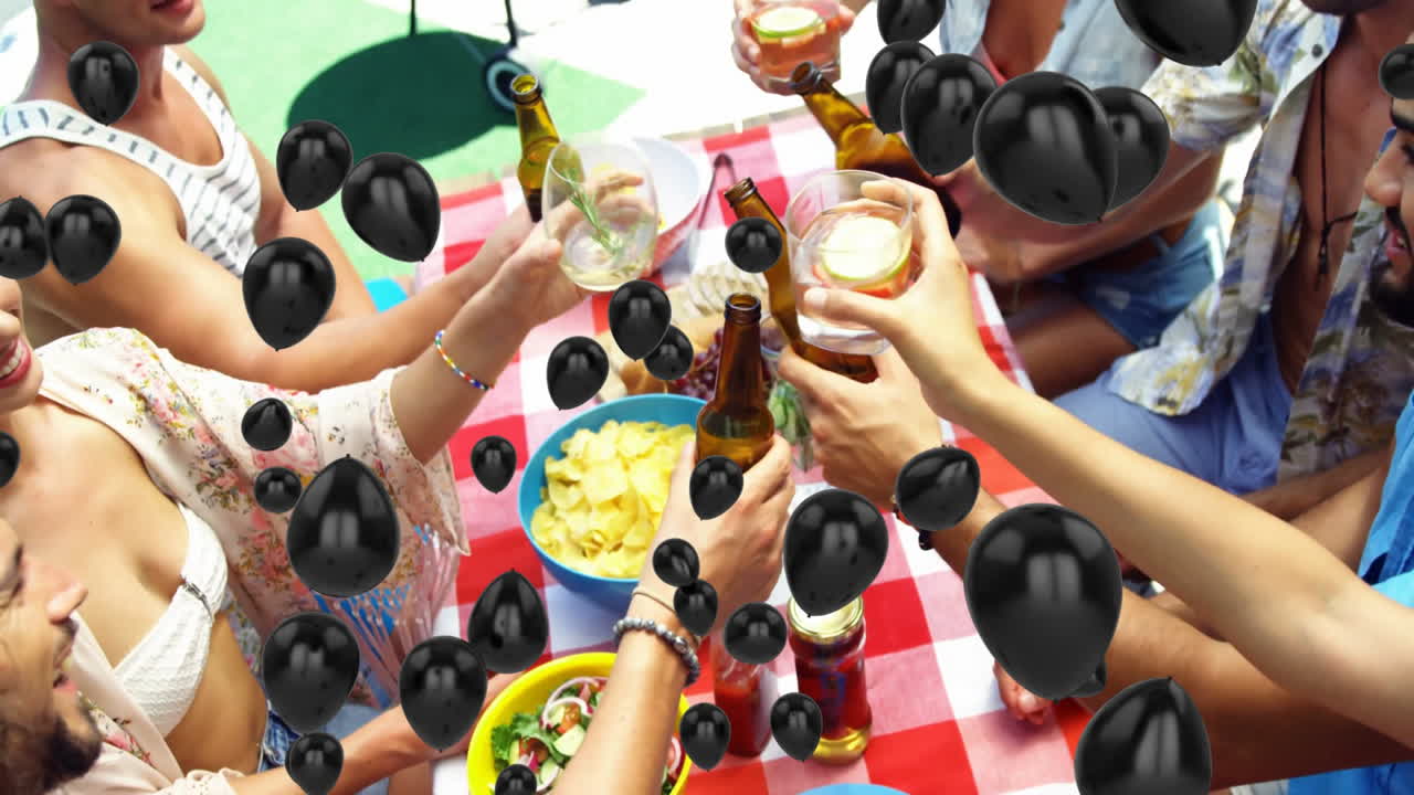People clinking beer bottles over table with floating black balloons animation