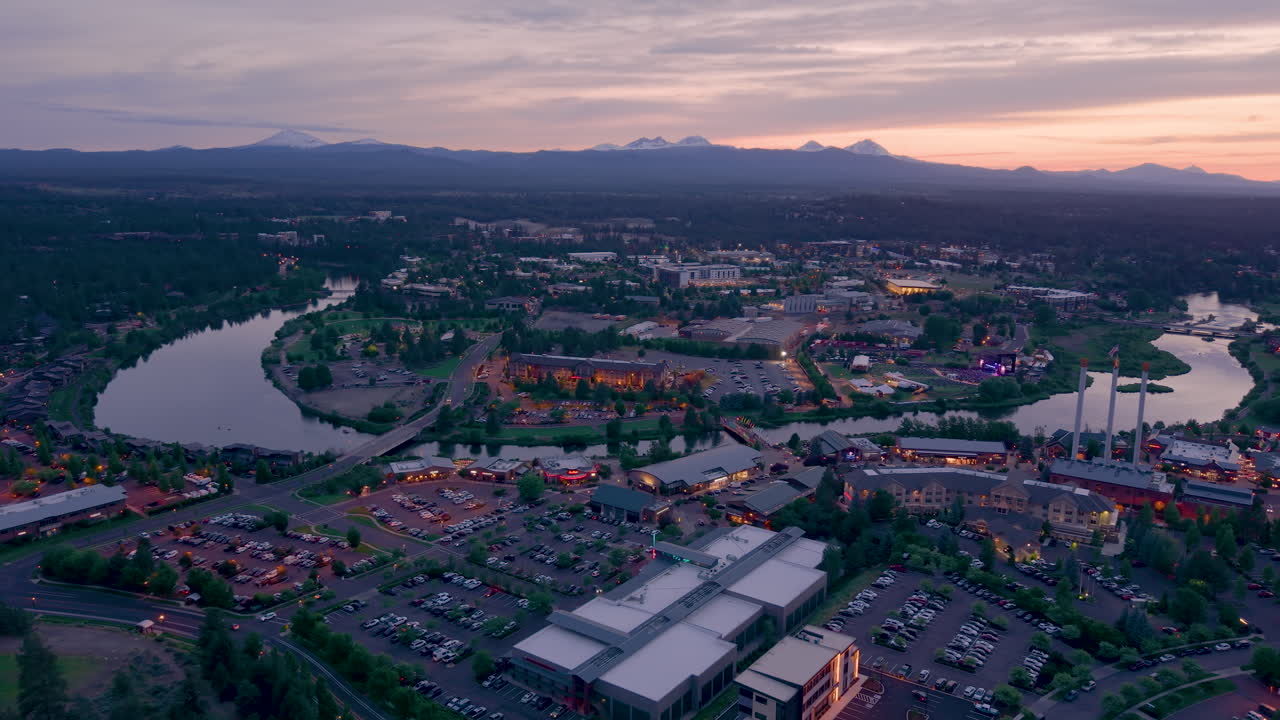 Aerial pullback shot of Bend Oregon. Cityscape after sunset.