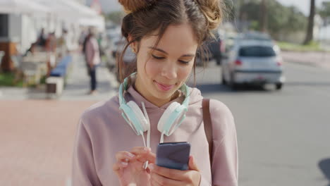 portrait of beautiful young hispanic woman using smartphone texting online browsing enjoying sharing summer vacation experience messaging social media on busy beachfront