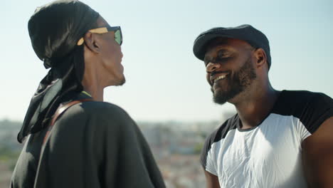 cámara lenta de la feliz pareja gay afroamericana hablando al aire libre