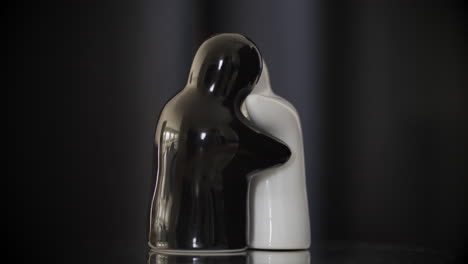 white and black porcelain dolls hugging each other