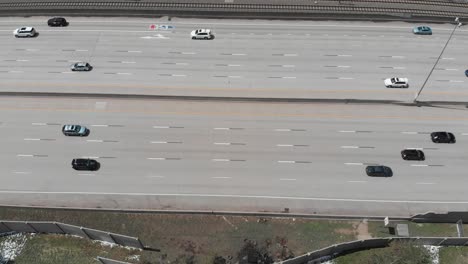 An-overhead-shot-of-cars-sprinting-along-a-freeway