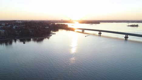 Wide-aerial-shot-that-quickly-tracks-towards-the-moving-boat-and-whips-around-to-follow-it-as-it-passes-the-camera