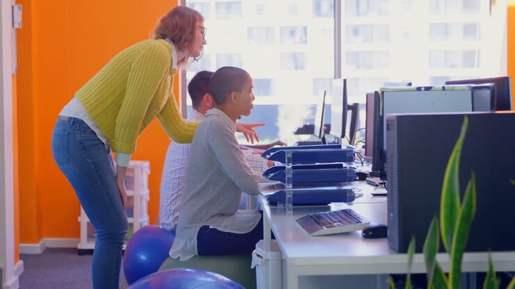 Side view of young caucasian business team discussing over computer in office 4k