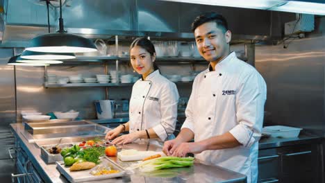 Two Professional Chefs Preparing Ingredients in a Commercial Kitchen