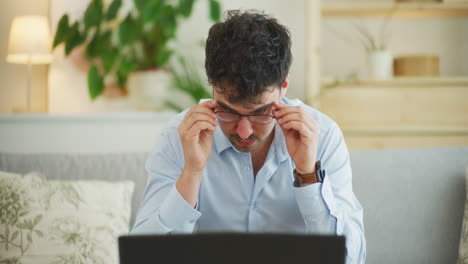 Concentrated-Pensive-Businessman-Working-on-Laptop-in-Office