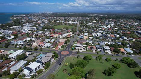 the paradise road and roundabout near the boat harbour park at the paradise point coastal suburb in queensland, australia