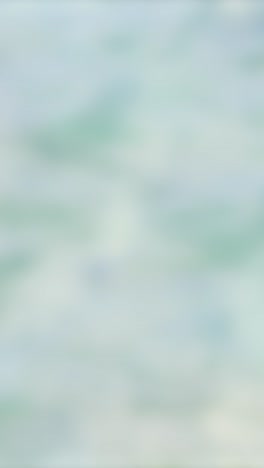 un bucle sin fisuras de ondas suaves del océano creando un fondo calmante y texturizado con movimiento sutil y tonos pastel