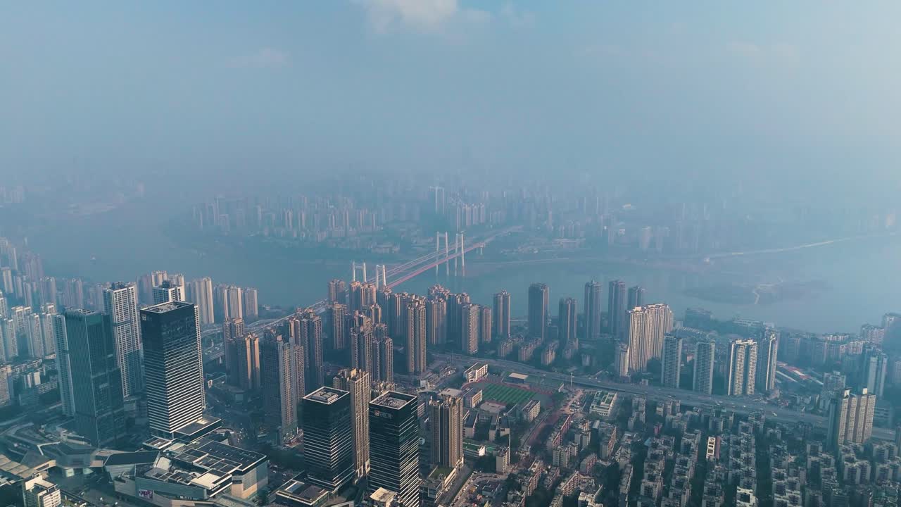 Aerial view of Chongqing city shrouded in extreme pollution and smog, capturing the dense urban landscape, high-rise buildings, and the river fading into the haze.