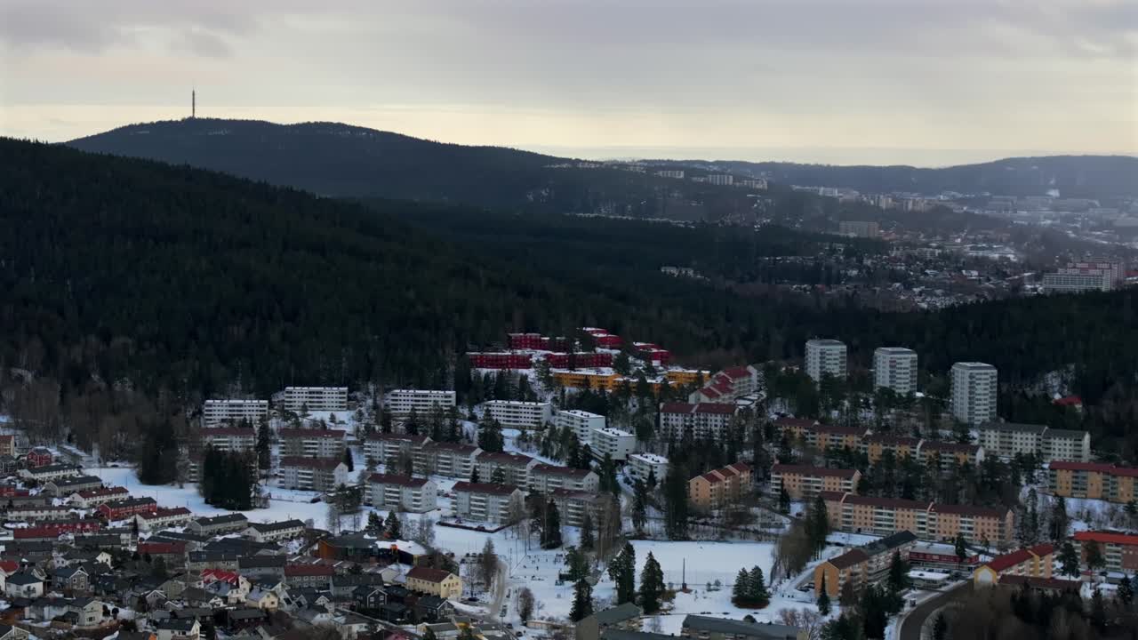 Tonsenhagen Bjerke Arvol Oslo Norge Norway aerial drone city neighborhood apartment buildings Gamle cold cloudy winter day gray skies morning Skisenter resort mountain landscape circle right motion